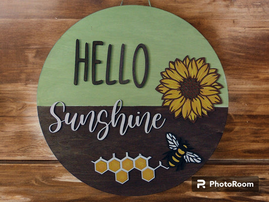 Brighten up your entryway this summer with our charming "Hello Sunshine" Sunflower Bee Door Hanger! This delightful piece is perfect for adding a touch of warmth and cheer to your front door, porch, or any space in your home. Each door hanger is lovingly handcrafted, ensuring that every piece is unique and may vary slightly from the picture, adding a personal touch to your decor.